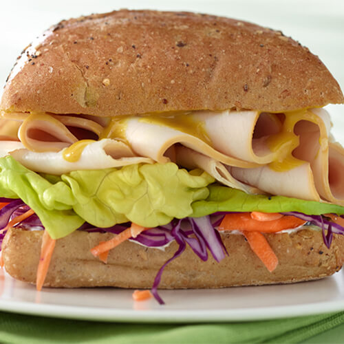 Sandwich rolls filled with fresh veggies, premium turkey breast, honey mustard, and herbed cream cheese.