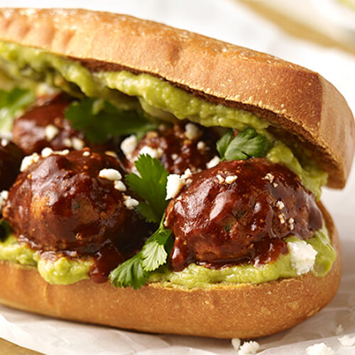 Turkey meatballs simmered in Chipotle salsa and Mexican spices topped with guacamole, cilantro, and feta cheese, on a toasted sandwich roll.