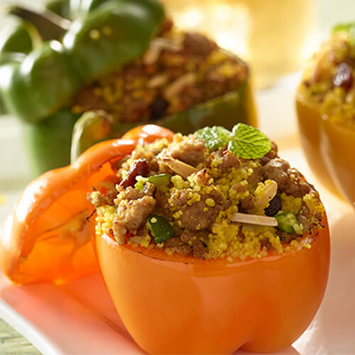 Orange, yellow, red, and green bell peppers are stuffed with lean turkey sausage, mint, and garlic.