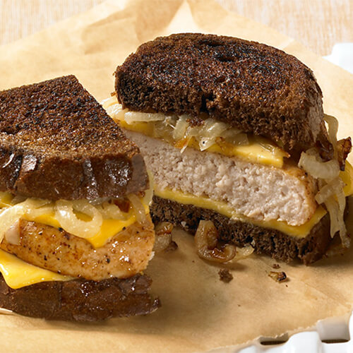 JENNIE-O® Turkey Burger patty topped with cheese and sauerkraut on toasted rye bread.