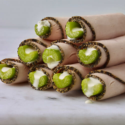 Nine stalks of celery covered in blue cheese and rolled-up in turkey meat.