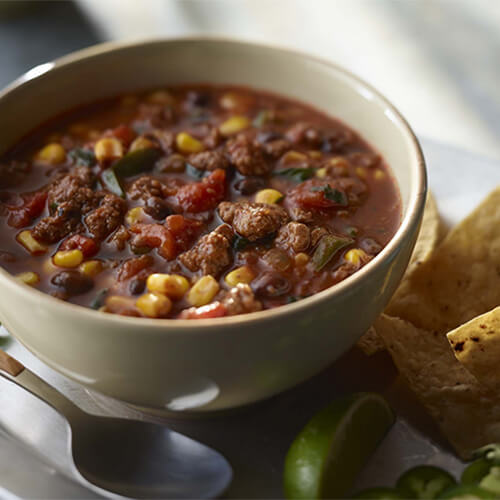 Delicious bowl of turkey enchilada chili made with corn and peppers.