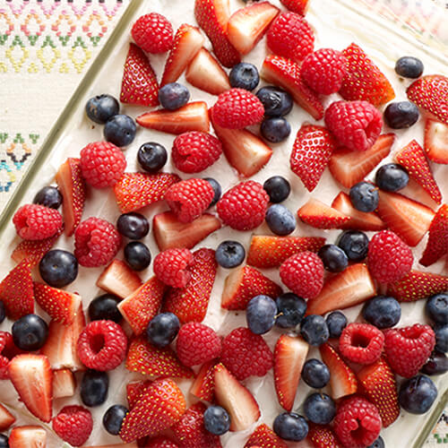 A delicious cake made from vanilla cake, whipped cream and a variety of berries.