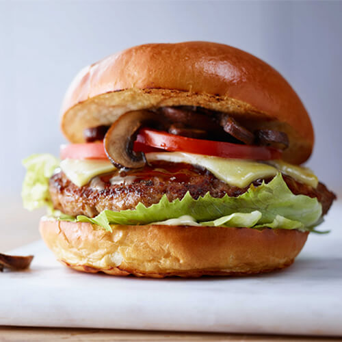 Turfuffle turkey burger with cheese on a white tray.