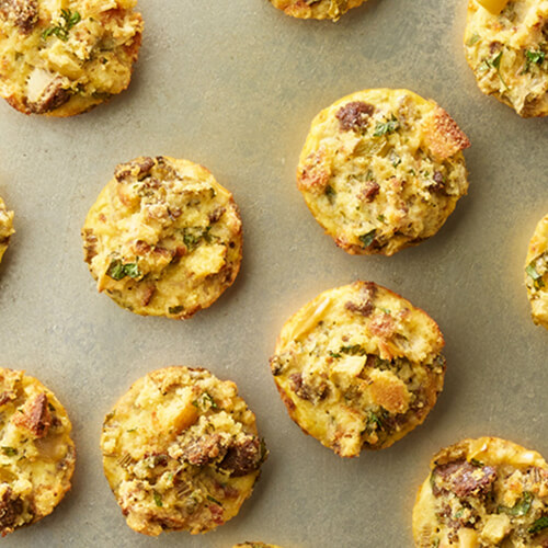 Turkey sausage and apple stuffing bites on a grey table.